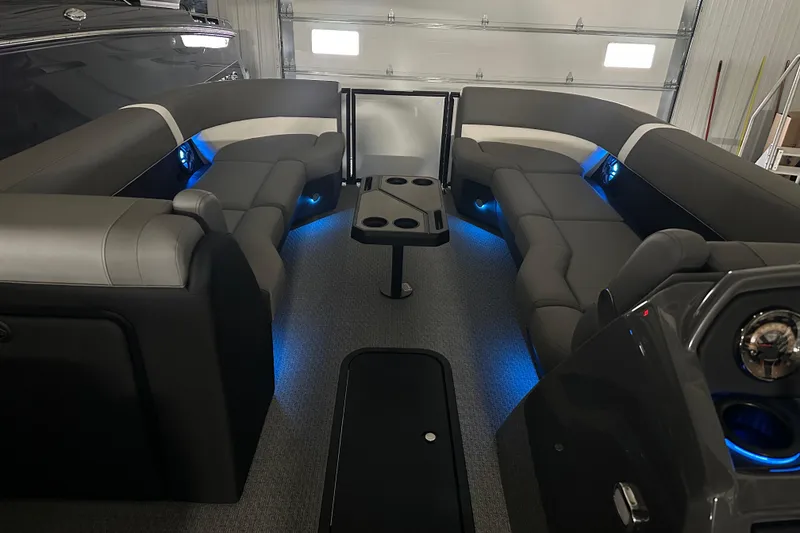 Slide: The Image of 2026 Evotti 525QL boat with Mercury outboard motor and boarding ladder in a showroom. - 7