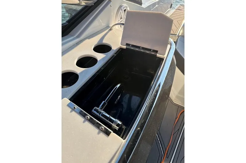 Slide: The Image of 2023 Monterey 298SS Super Sport boat sink and cup holders on deck. - 10
