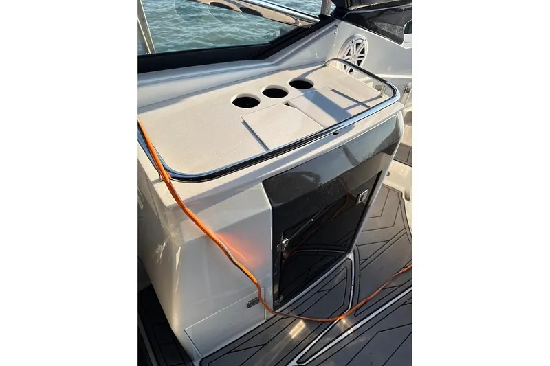 Slide: The Image of 2023 Monterey 298SS Super Sport boat interior with sleek design and cup holders. - 11