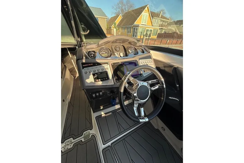 Slide: The Image of 2023 Monterey 298SS Super Sport boat dashboard with steering wheel and control panel. - 16