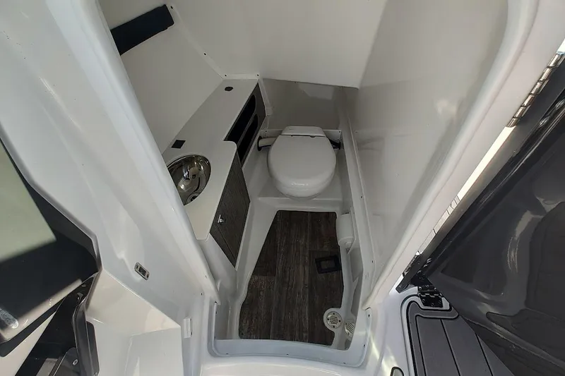 Slide: The Image of 2023 Monterey 298SS Super Sport boat bathroom with toilet and sink. - 18