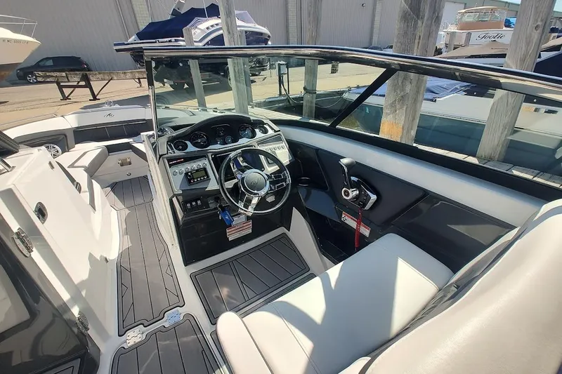 Slide: The Image of 2023 Monterey 298SS Super Sport boat interior with steering wheel and seating. - 19