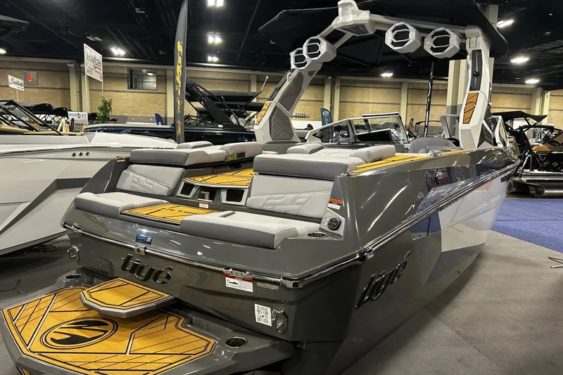 Slide: The Image of 2026 Tigé Ultré 23ZX boat displayed indoors, featuring sleek design and modern seating. - 12