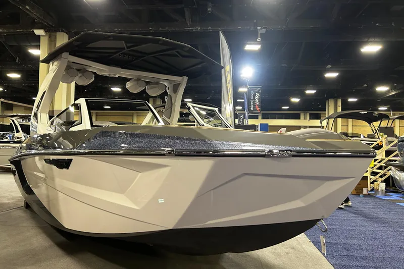 Slide: The Image of 2026 Tigé Ultré 23ZX boat displayed indoors at a boat show. - 14