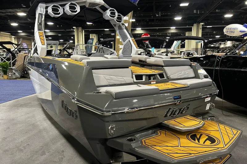 Slide: The Image of 2026 Tigé Ultré 23ZX boat with sleek design and modern features at an indoor exhibition. - 3