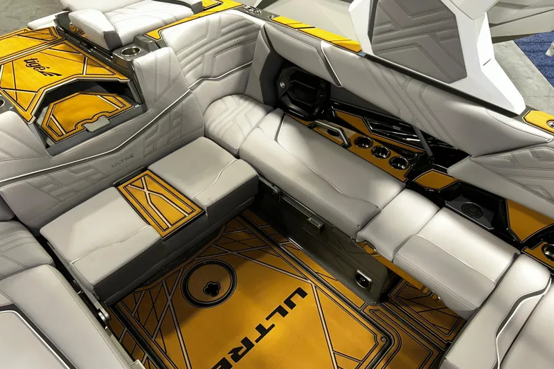 Slide: The Image of 2026 Tigé Ultré 23ZX boat interior with luxurious gray seating and vibrant yellow accents. - 8