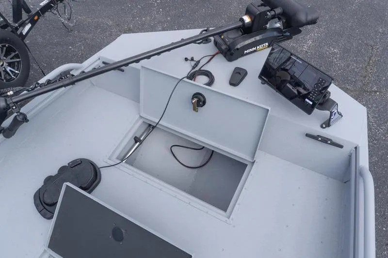 Slide: The Image of 2026 G3 Sportsman 2400 boat deck with Minn Kota trolling motor and storage compartments. - 16