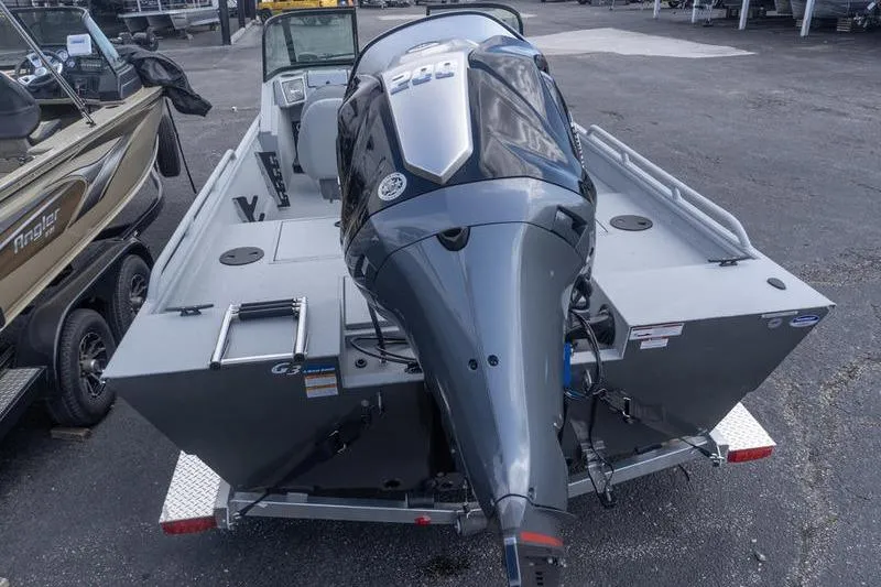 Slide: The Image of 2026 G3 Sportsman 2400 boat with powerful outboard motor, parked on a trailer. - 7