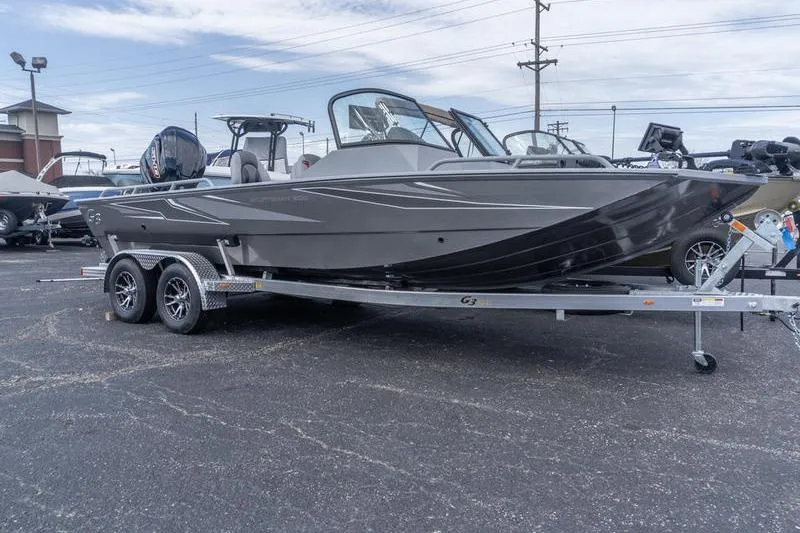 The Image of 2026 G3 Sportsman 2400 boat on trailer in parking lot, side view. - 1
