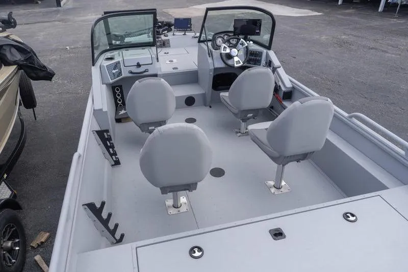 Slide: The Image of 2026 G3 Sportsman 2400 boat interior with four seats and steering console. - 10
