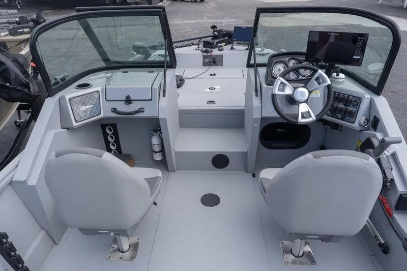 Slide: The Image of 2026 G3 Sportsman 2400 boat interior with dual seats, steering wheel, and control panel. - 11