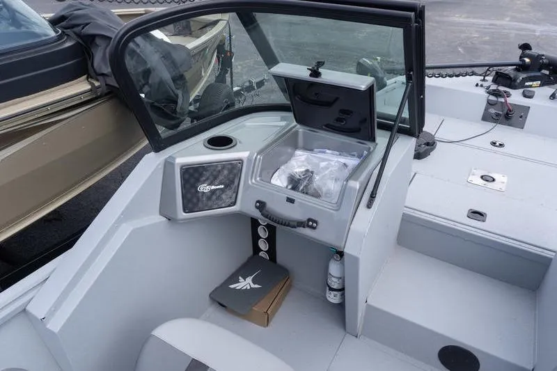 Slide: The Image of 2026 G3 Sportsman 2400 boat interior with open storage compartment and seating area. - 12