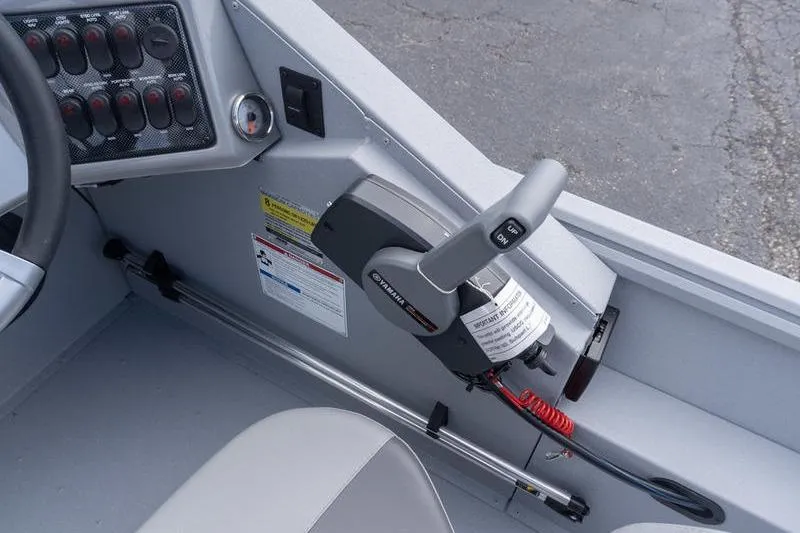 Slide: The Image of 2026 G3 Sportsman 2400 boat interior with control panel and throttle lever. - 13