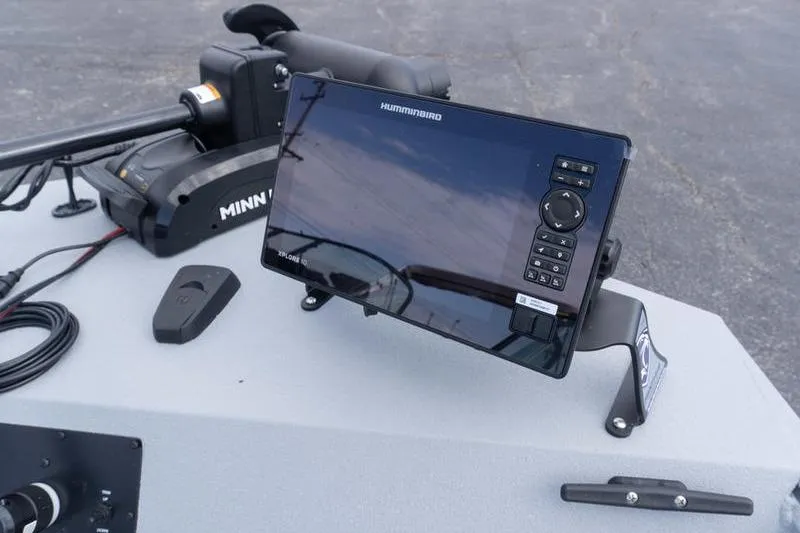 Slide: The Image of 2026 G3 Sportsman 2400 boat dashboard with Humminbird fish finder and Minn Kota trolling motor. - 17