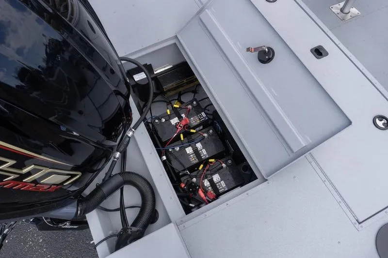Slide: The Image of 2026 G3 Sportsman 2400 boat battery compartment with motor and wiring. - 23