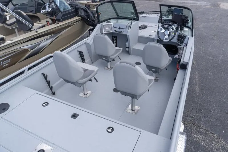 Slide: The Image of 2026 G3 Sportsman 2400 boat interior with four seats and steering console. - 9