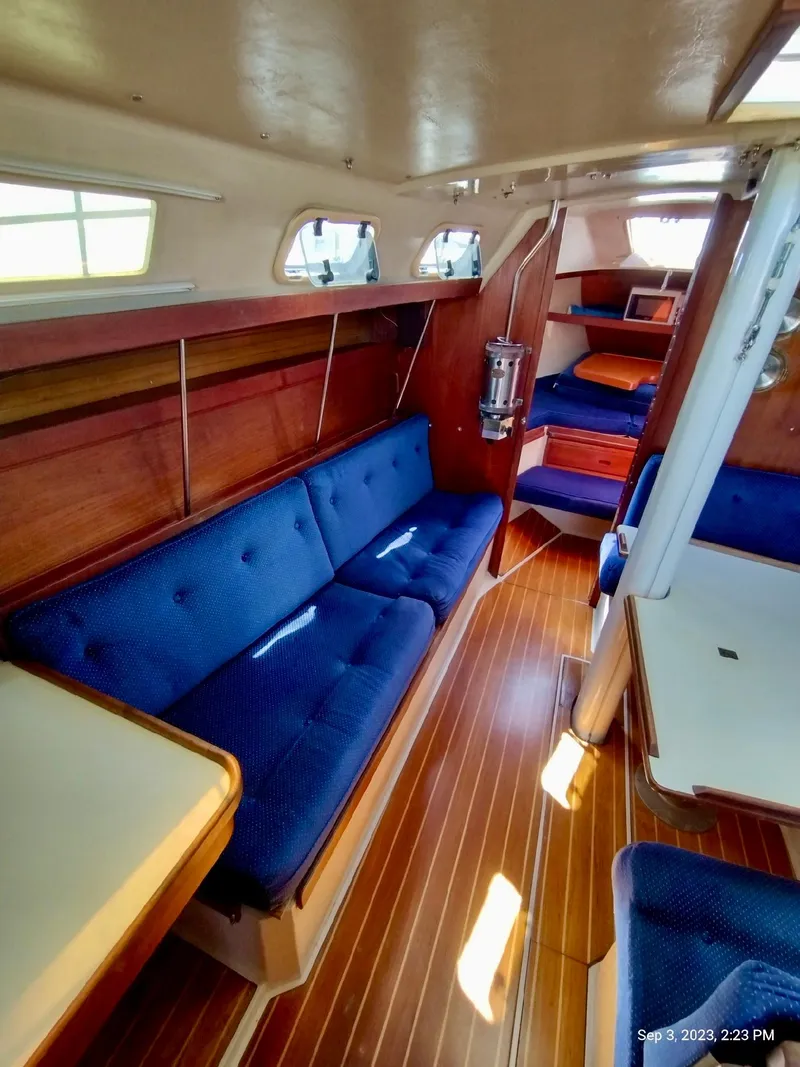 Slide: The Image of Interior of a 1987 Catalina 34 yacht with blue upholstery. - 10