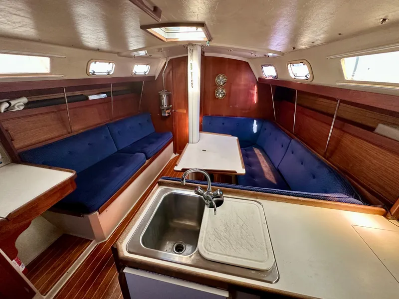 Slide: The Image of Interior of a 1987 Catalina 34 yacht with blue upholstery. - 12