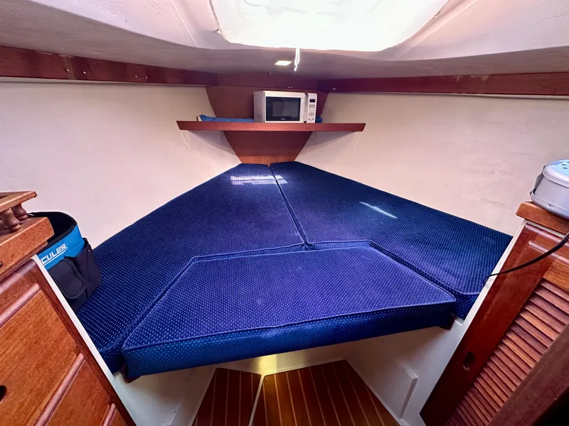 Slide: The Image of Interior of a 1987 Catalina 34 with blue upholstery and microwave. - 15