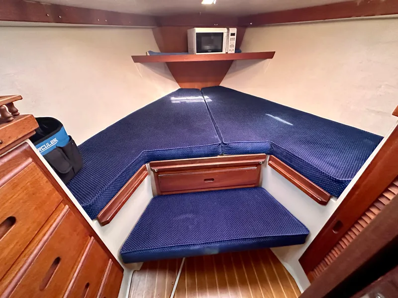 Slide: The Image of Interior of a 1987 Catalina 34 yacht with blue cushions. - 18