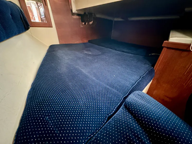 Slide: The Image of Interior cabin of 1987 Catalina 34 sailboat with blue upholstery. - 20