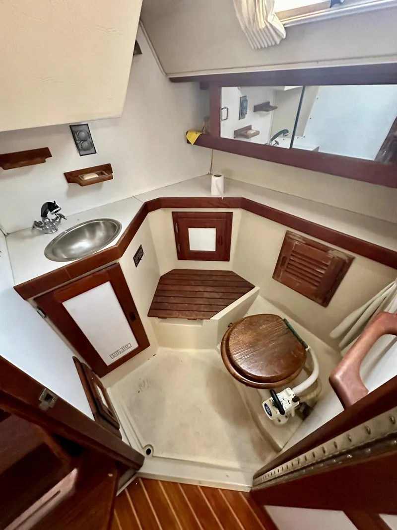 Slide: The Image of Interior of a 1987 Catalina 34 yacht with wooden accents. - 22