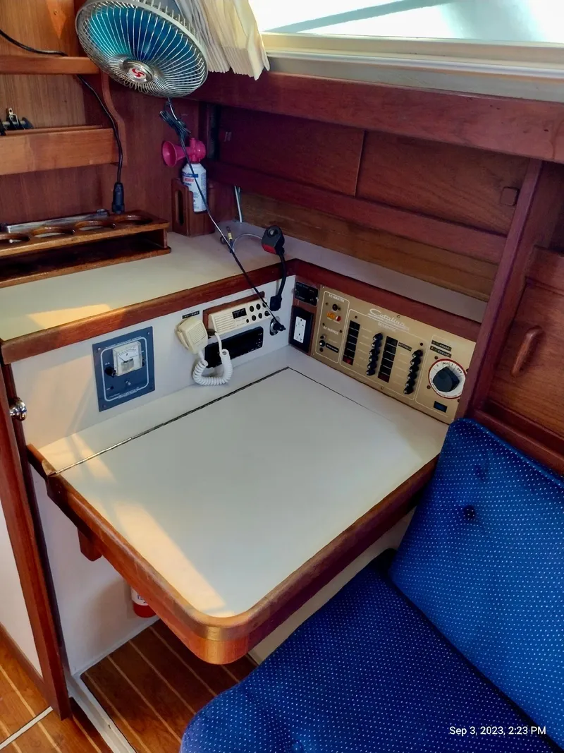 Slide: The Image of Navigation area of a 1987 Catalina 34 yacht with controls and seating. - 24