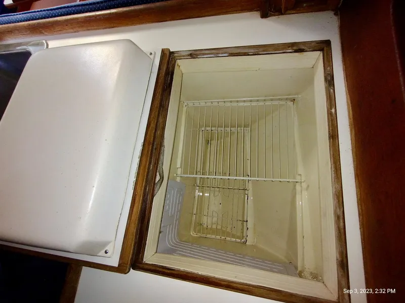 Slide: The Image of Interior of a 1987 Catalina 34 refrigerator with wire shelf. - 28