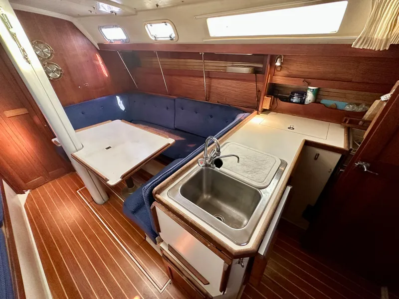 Slide: The Image of Interior of a 1987 Catalina 34 yacht with kitchen and seating area. - 8