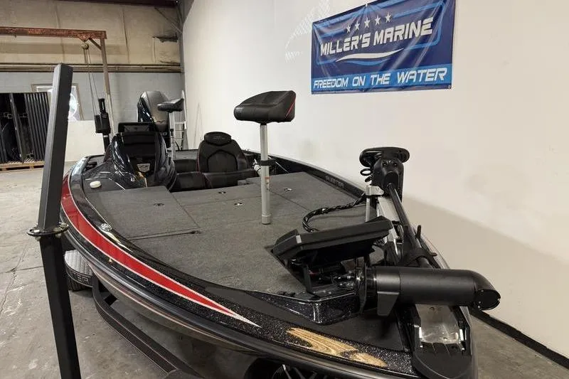 Slide: The Image of 2022 Skeeter ZX150 bass boat in showroom, featuring trolling motor and fishing seats. - 4