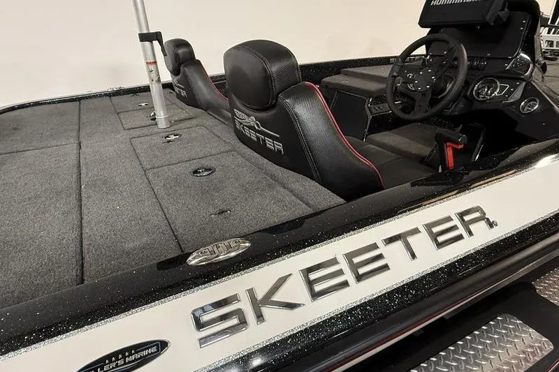 Slide: The Image of 2022 Skeeter ZX150 boat interior with steering wheel and seating. - 9
