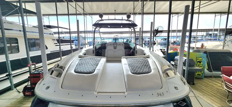 Slide: The Image of 2007 Cobalt 343 boat docked in a marina, showcasing sleek design and spacious seating. - 11