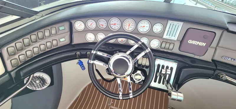 Slide: The Image of 2007 Cobalt 343 dashboard with steering wheel, gauges, and Garmin navigation system. - 16
