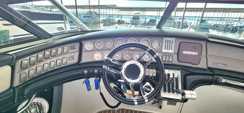 Slide: The Image of Cockpit of 2007 Cobalt 343 boat with steering wheel and Garmin navigation system. - 22