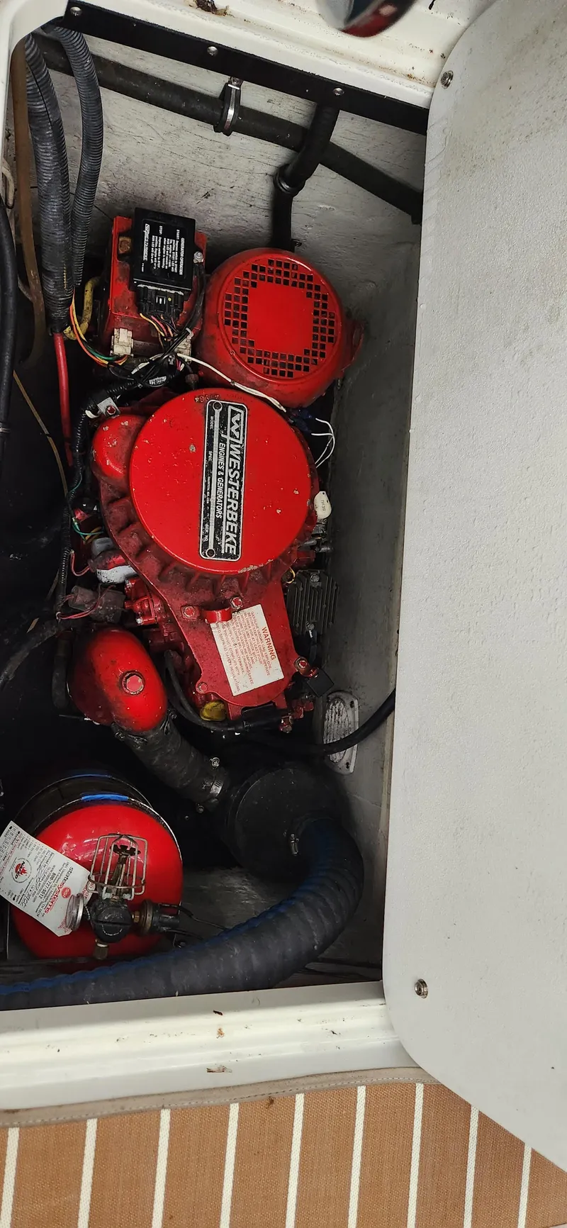 Slide: The Image of Engine compartment of a 2007 Cobalt 343 boat, featuring red engine components. - 34