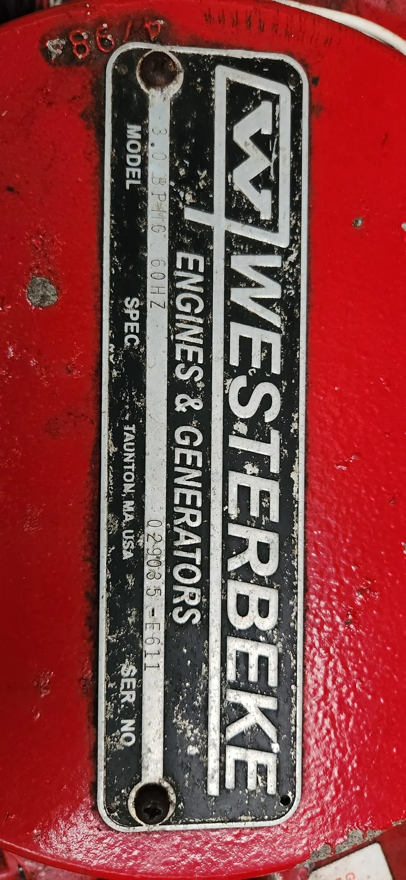 Slide: The Image of Westerbeke engine label on red surface, model details visible. - 35