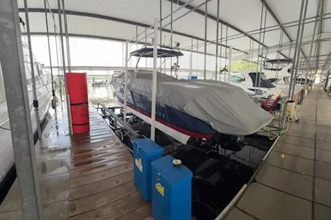Slide: The Image of Covered 2007 Cobalt 343 boat docked in a marina with protective canopy. - 40