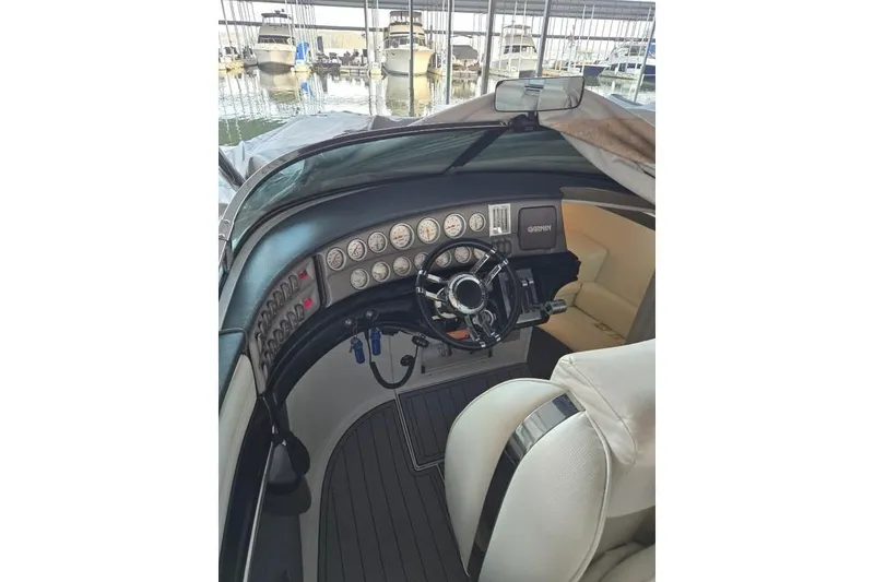 Slide: The Image of 2007 Cobalt 343 boat cockpit with steering wheel and gauges, docked in marina. - 44