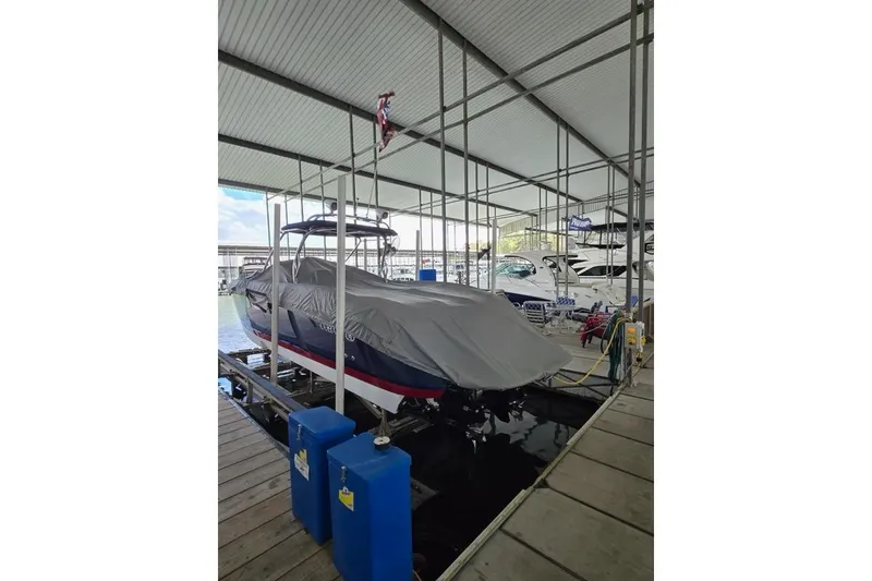 Slide: The Image of Covered 2007 Cobalt 343 boat docked in a marina under a metal roof. - 45