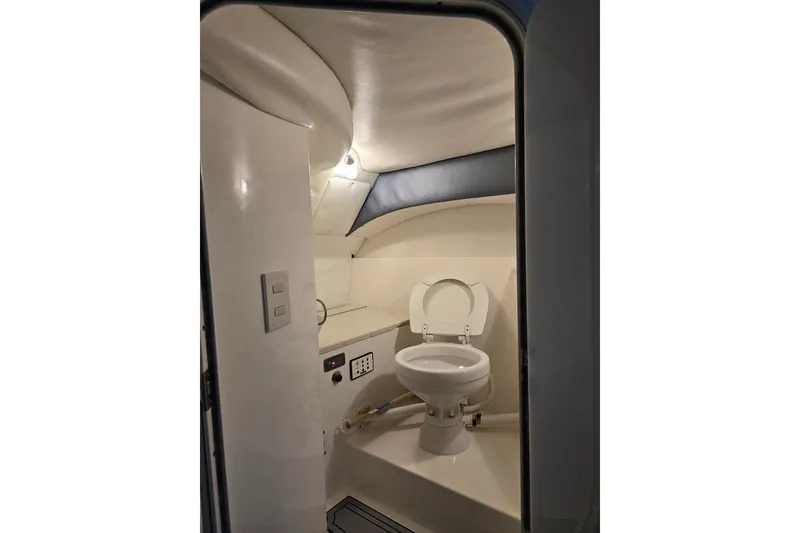 Slide: The Image of Interior of a 2007 Cobalt 343 boat bathroom with toilet and lighting. - 49