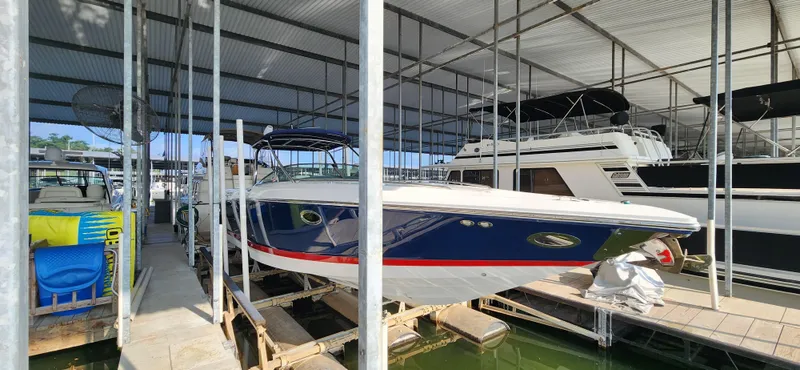 Slide: The Image of 2007 Cobalt 343 boat docked in a covered marina, side view. - 5
