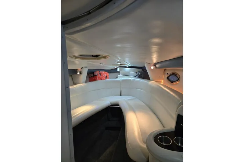 Slide: The Image of Interior of a 2007 Cobalt 343 boat with white leather seating and cup holders. - 53