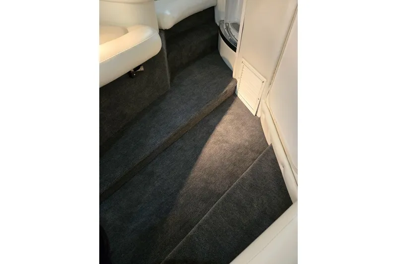 Slide: The Image of Interior of 2007 Cobalt 343 boat with carpeted steps and white seating. - 55