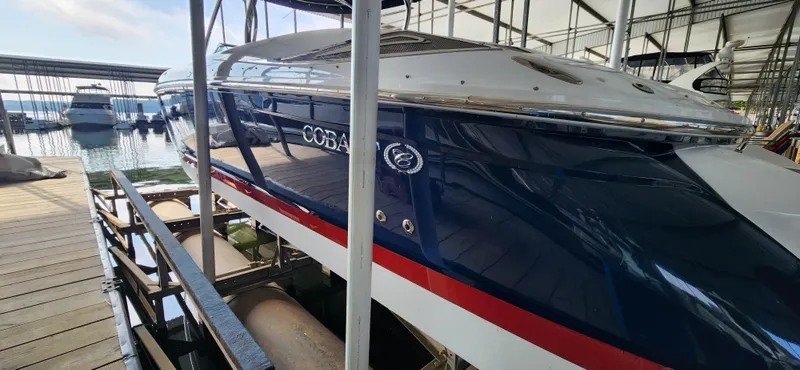 Slide: The Image of 2007 Cobalt 343 boat docked in a marina, side view. - 6