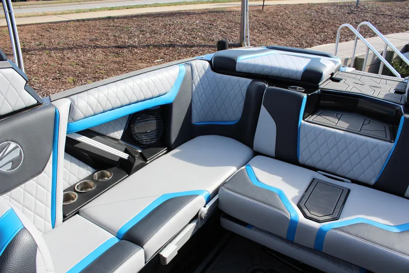 Slide: The Image of 2023 Tigé 23ZX boat interior with blue and gray quilted seating and cup holders. - 10