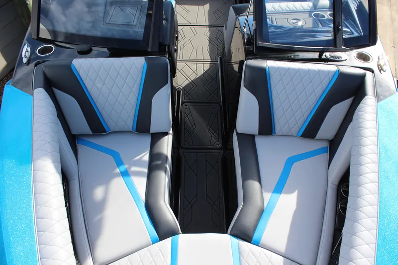 Slide: The Image of 2023 Tigé 23ZX boat interior with stylish blue and gray seating design. - 14