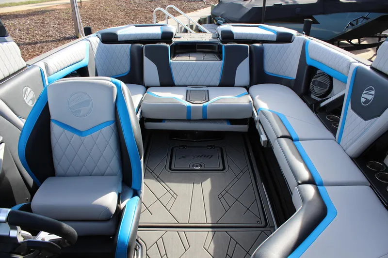 Slide: The Image of 2023 Tigé 23ZX boat interior with modern seating and blue accents. - 15