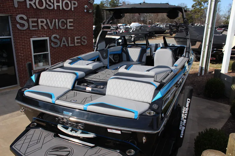 Slide: The Image of 2023 Tigé 23ZX boat displayed at a pro shop, featuring luxurious seating and modern design. - 6