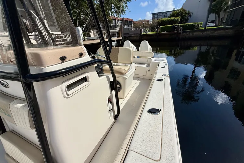 Slide: The Image of 2018 Sea Chaser 24 HFC boat docked by a calm waterfront. - 12