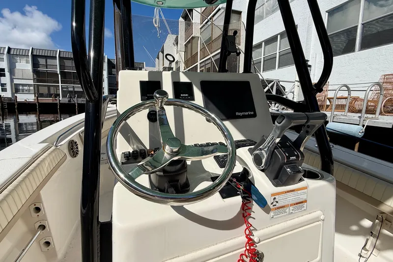 Slide: The Image of 2018 Sea Chaser 24 HFC boat helm with steering wheel and Raymarine display. - 16